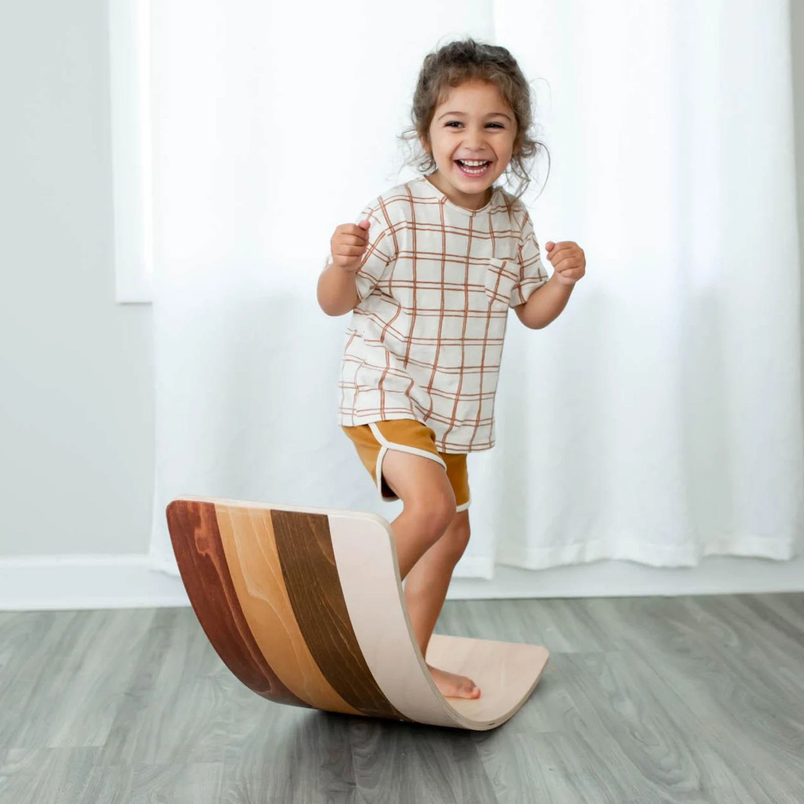 Image of young girl playing on a wobble board.