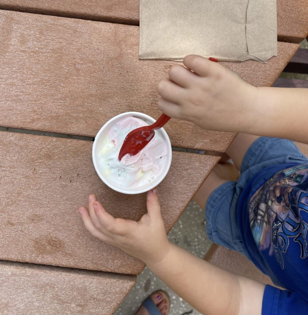 Essential End of Summer Reading Checklist for Families. Aerial picture of child eating ice cream.