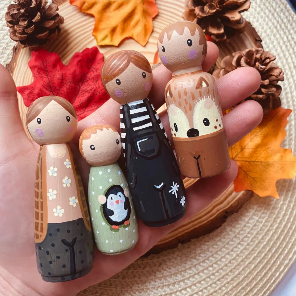 Image of customizable peg people that are painted.